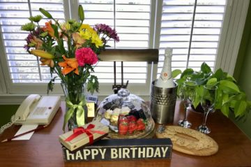 Happy Birthday decor with flowers, chocolate, and wine