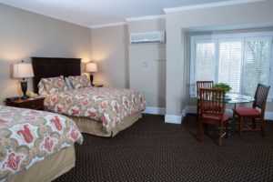 Two beds in the family suite guest room at Davidson Village Inn