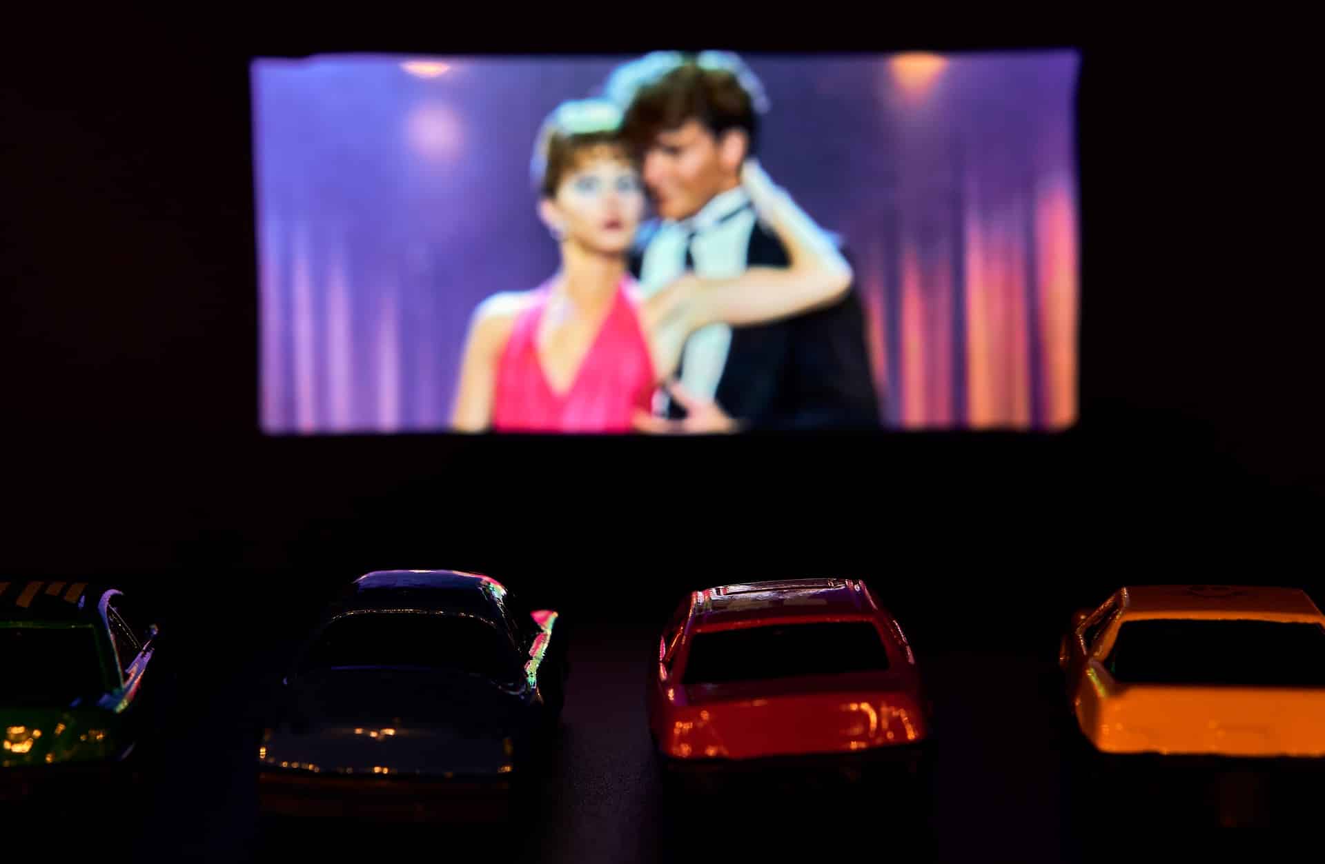 The movie Dirty Dancing playing on the screen of a drive-in movie theater