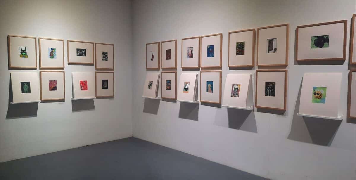 Art gallery wall featuring framed contemporary artwork at a museum near Davidson, NC.