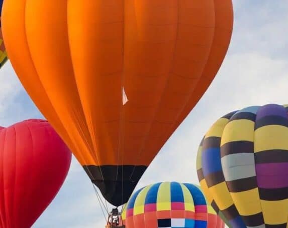 Multi-colored hot air balloons in a blue sky