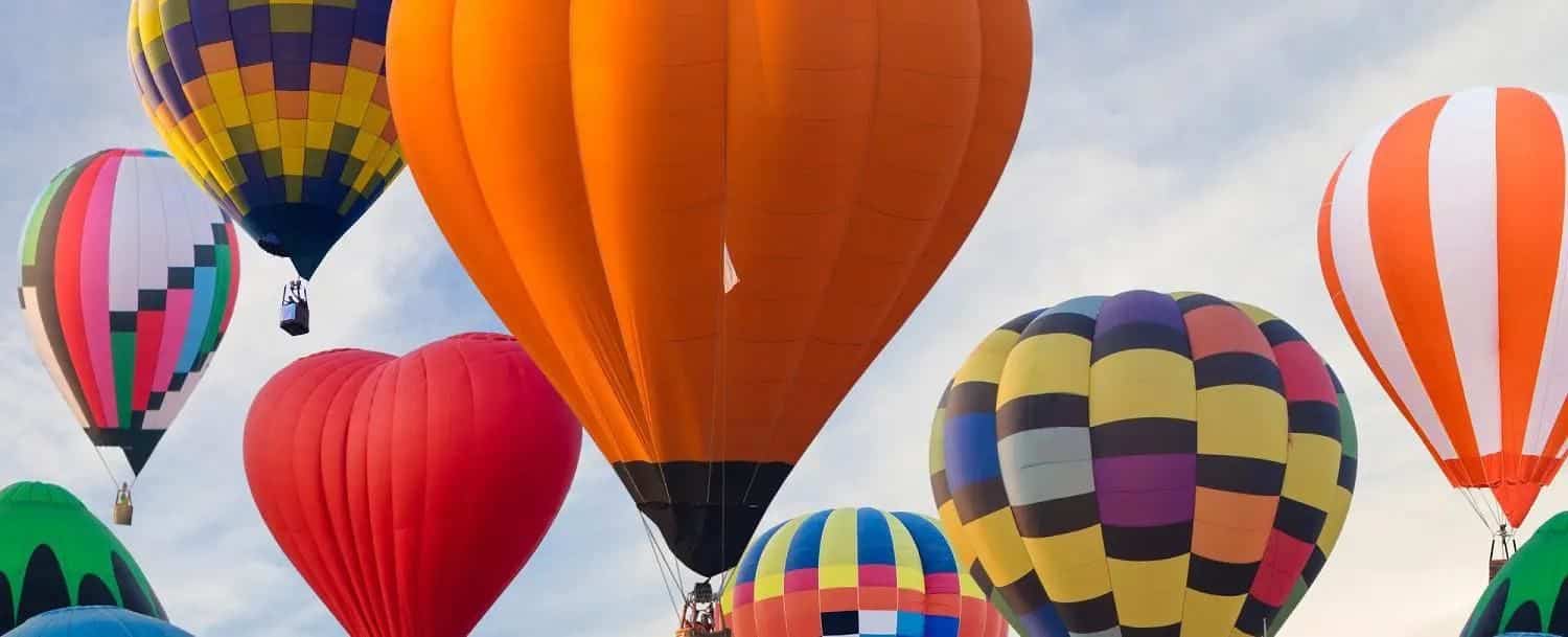 Multi-colored hot air balloons in a blue sky