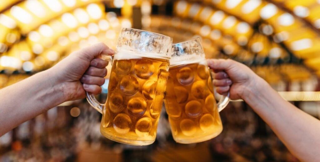 Two beer steins clink together at Hickory Oktoberfest near Davidson, NC.