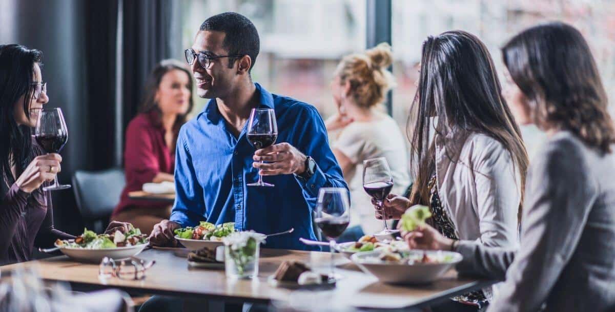 several people enjoying a healthy dinner after a business meeting