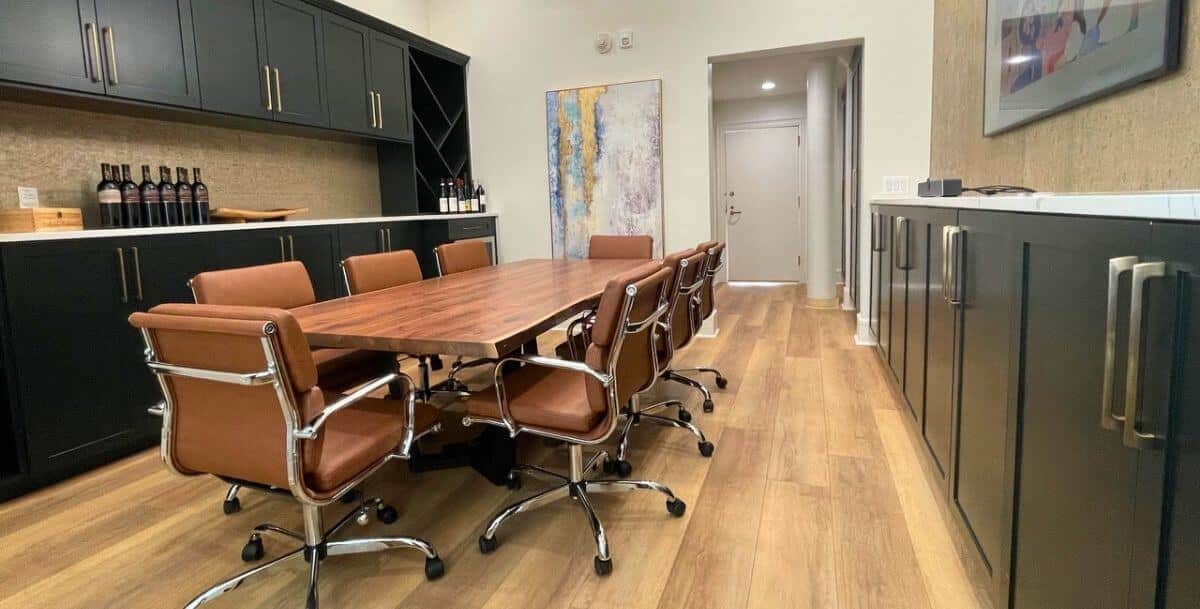 private conference room with table chairs and hdtvs for meetings at davidson village inn