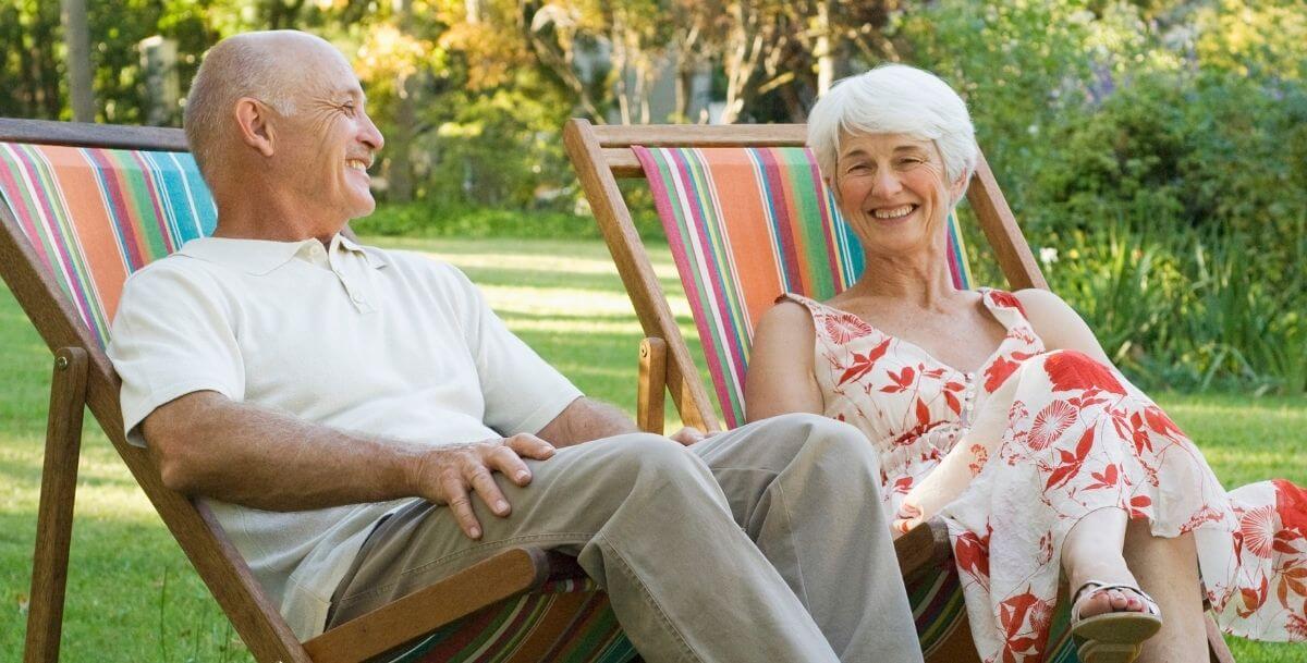 Couple relaxing in colorful lawn chairs outdoors on a sunny afternoon near Davidson, NC