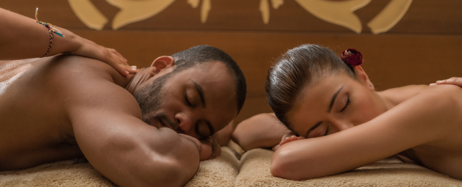 couple lying down head to head getting a massage 