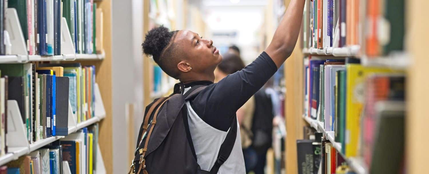 College student looking for a book in the library