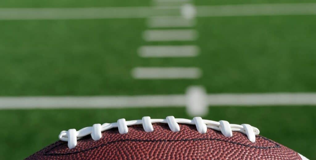 Football resting on the field before kickoff during a Davidson College fall sports weekend