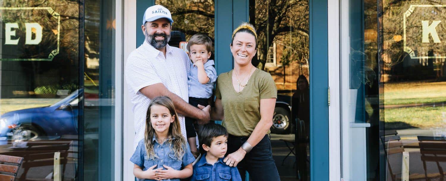 joe, katy and their children in front of kindred davidson