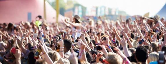 fan crowd cheering at an outdoor music festival