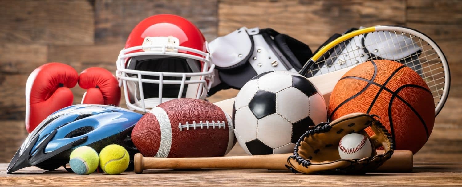Collection of sports equipment including basketball, football, soccer ball, baseball, tennis racket, and helmet