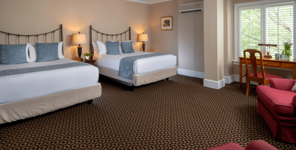 Spacious family suite at Davidson Village Inn with two queen beds and seating area