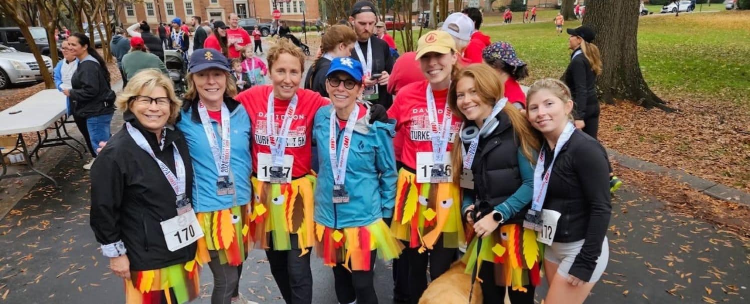 Runners in turkey costumes celebrate after the Davidson Turkey Trot 5k near Davidson College.