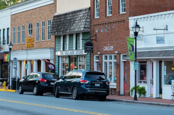 Cars parked along street in front of brick stores on Main Street in Davidson