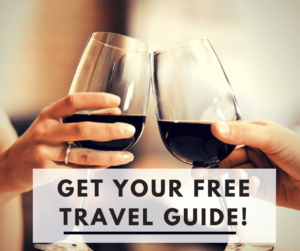 People with wine glasses and the text, "Get Your Free Travel Guide!"